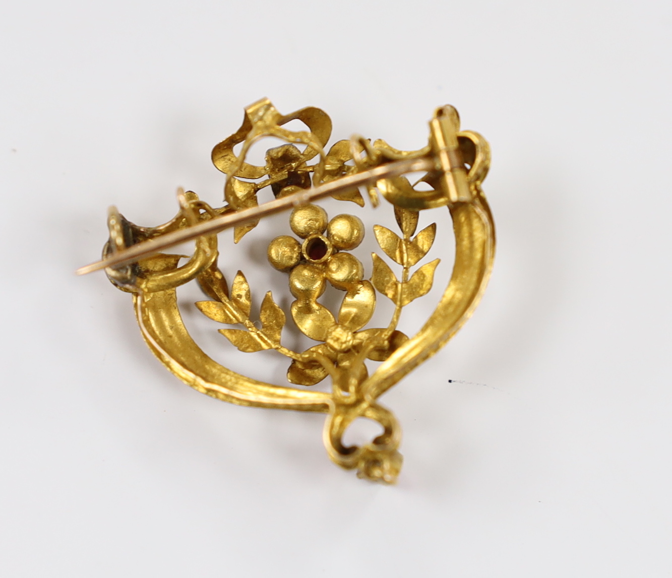 An early 20th century French two colour yellow metal (18ct poincon mark), rose cut diamond, ruby and split pearl set drop pendant brooch, 36mm, gross weight 4 grams.